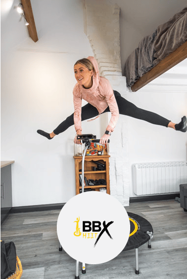 Lady doing a split leap on her mini trampoline with a link to more information about the boogie bounce H.I.I.T programme.
